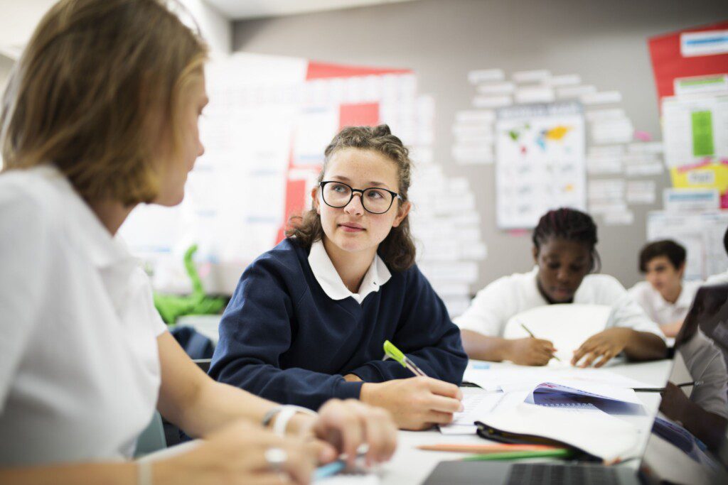 Students talking about needs for functional skills in a uk classroom.